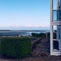 Ocean views stretch out from the property, where coastal breezes meet well-tended grounds. The blue horizon frames a peaceful setting perfect for a seaside escape.