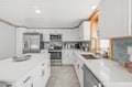 You'll have everything you need in this bright, spotless kitchen: modern stainless appliances, tons of counter space, and a window bringing in warm natural light as you prep meals.