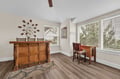 Gather around your elegant dining space featuring rich wood furnishings and beautiful natural light streaming through large windows.