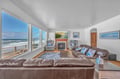 Sink into plush leather seating while ocean waves crash just outside your window. The fireplace adds warmth to your beachfront sanctuary.
