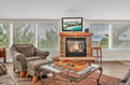 Cozy up by your stone fireplace while enjoying the warm ambiance and tropical views on the mounted TV.