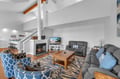 Cozy up in your spacious living room with plush seating, crackling fireplace, and modern amenities for perfect relaxation.