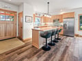 You'll love gathering around this spacious kitchen island with premium appliances, warm wood cabinetry, and stylish bar seating perfect for morning coffee or evening meals.