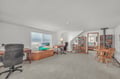 Your upstairs retreat combines workspace and relaxation with ocean views, cozy seating, and shelves of books to inspire.