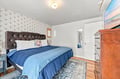 Sink into a luxurious tufted headboard and wrap yourself in soft linens. Your peaceful retreat awaits, complete with charming vintage touches and easy access to a private ensuite.