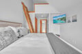 Your cozy bedroom features a comfortable bed and wooden ladder to your private loft space above.
