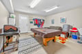 Your private game room awaits with pool table, pinball machine, and cozy seating - perfect for friendly competition and relaxation.