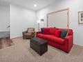 Relax in your vibrant red sofa and cozy leather chair - perfect for unwinding after exploring the city.