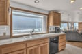 Cook while gazing at stunning ocean waves through your kitchen's panoramic windows, where culinary moments meet coastal tranquility.