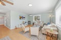 Relax in your serene living room with plush seating, warm wood floors, and gentle natural light streaming through large windows—perfect for unwinding after a day of adventure.