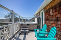 Soak in your private hot tub or relax in vibrant Adirondack chairs on this sunny deck, where ocean breezes and coastal views create the perfect escape.