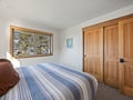Wake up to treetop views in your cozy bedroom, where warm wood accents and crisp linens create the perfect mountain retreat.