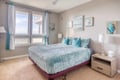 Drift off in your coastal-themed bedroom where ocean-inspired artwork and turquoise linens create a serene retreat.