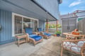 Unwind on your private covered patio with comfortable wicker seating and peaceful garden views.