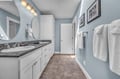 Step into your serene bathroom retreat with spa-like blue walls, granite counters, and fluffy towels awaiting your arrival.