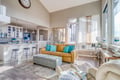 Unwind in this bright open-concept living space where natural light floods through floor-to-ceiling windows, creating the perfect backdrop for relaxation.