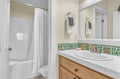 Your private bathroom features a colorful tile backsplash, spacious vanity, and tub-shower combo for refreshing starts to each day.