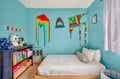 Your kids will love this cheerful turquoise common area with colorful kites, toys, and books to spark their imagination and adventure.