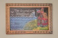 A charming chalkboard art piece celebrates the heritage of this historic 1926 schoolhouse, featuring hand-drawn coastal scenery and an American flag—a warm nod to the property's unique story.