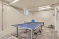 Challenge friends to ping pong matches in your private game room, complete with paddles ready for competitive fun.