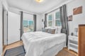 Rest peacefully in your bright bedroom featuring crisp linens, modern furnishings, and calming coastal artwork that sets the perfect tone for relaxation.