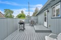 Picture yourself grilling up a feast while relaxing at this spacious deck with comfortable seating, perfect for soaking up the sun and enjoying outdoor meals in your private retreat.