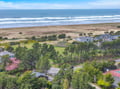 Stunning coastal community with pristine beach access, lush green spaces, and charming homes nestled between ocean and countryside.