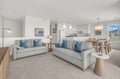 Settle into this light-filled living space where coastal-inspired decor meets modern comfort. Plush sofas invite you to unwind, while the open kitchen and dining area make meal times effortless.