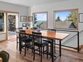Gather around your spacious dining table with stunning water views through large windows that frame the peaceful scenery.