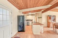 Warm wood-planked ceilings crown this inviting kitchen and dining area, where you'll find modern appliances and plenty of counter space for preparing meals together during your stay.