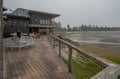 This waterfront property features a spacious deck stretching along the shoreline, offering direct access to peaceful coastal views and the surrounding natural landscape.