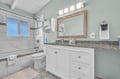 Refresh in your beautifully renovated bathroom with granite counters, soft lighting, and pristine shower-tub combo.