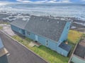 Oceanfront cottage positioned directly on the Pacific coastline with immediate beach access and dramatic waves.