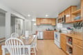 You'll love cooking meals in this bright, fully equipped kitchen with warm wood cabinets, modern appliances, and a cozy dining area perfect for your group.
