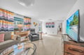 Unwind in your bright, modern living space with plush seating, vibrant décor, and entertainment ready for cozy evenings.