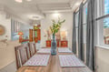 Gather around this inviting dining table, where thoughtful touches and abundant natural light create the perfect setting for your meals and conversations.