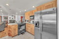 Your fully equipped kitchen awaits with stainless steel appliances, warm wood cabinetry, and an open layout perfect for preparing meals and gathering.