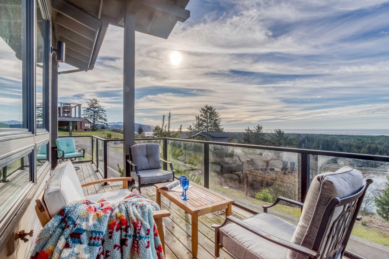 Unwind on your private deck with stunning views across forested landscapes and distant mountains, where comfortable seating awaits your morning coffee or evening relaxation.