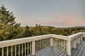 Beautiful forest and mountain views stretch across the horizon from this peaceful balcony at sunset.