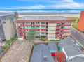 Beachfront property complex just steps from the sandy shore and rolling ocean waves.