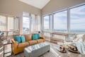 Relax in your bright living space with panoramic windows, plush leather seating, and sweeping views that stretch to the horizon.