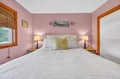 Drift into peaceful sleep in your cozy bedroom, where soft pink walls and warm lighting create the perfect retreat after your day.