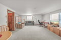 Relax in your spacious living room with comfortable seating, work desk, and entertainment center—perfect for unwinding after exploring.