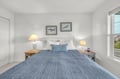 Your peaceful coastal bedroom awaits with soft linens, warm bedside lighting, and charming nautical artwork—perfect for restful nights after exploring the shore.