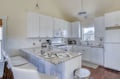 Step into your spacious, sun-filled kitchen where gleaming granite counters and crisp white cabinetry invite you to cook and gather around the breakfast bar.