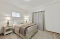 Sink into crisp linens and soft lighting in your peaceful bedroom retreat, complete with bedside lamps for late-night reading.