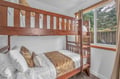 Your kids will love this cozy bunk bed setup with crisp linens and garden views for peaceful nights.