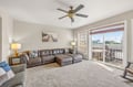 Sink into plush leather seating where your ceiling fan keeps you cool and large windows frame peaceful views of your private balcony.