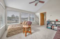 Relax in your bright living space with plush seating, entertainment center, and peaceful neighborhood views through large windows.
