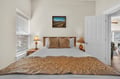 Drift into peaceful sleep in your elegantly appointed bedroom, where warm bedside lamps and crisp linens create the perfect retreat.
